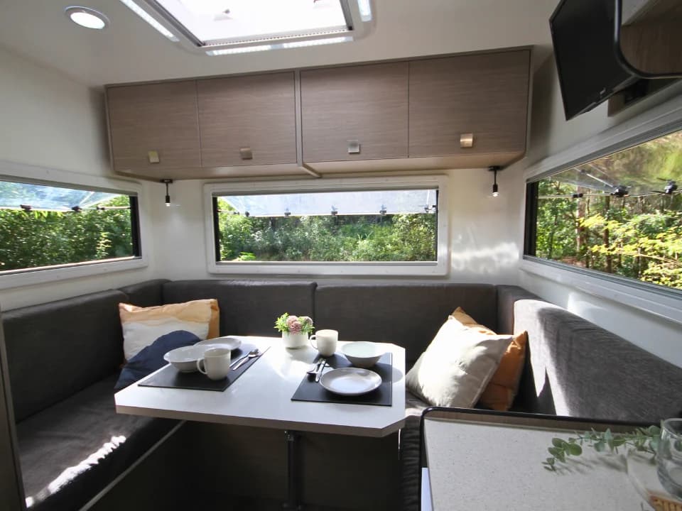Suncamper Saxby F-2 U-shaped lounge with dining table — interior